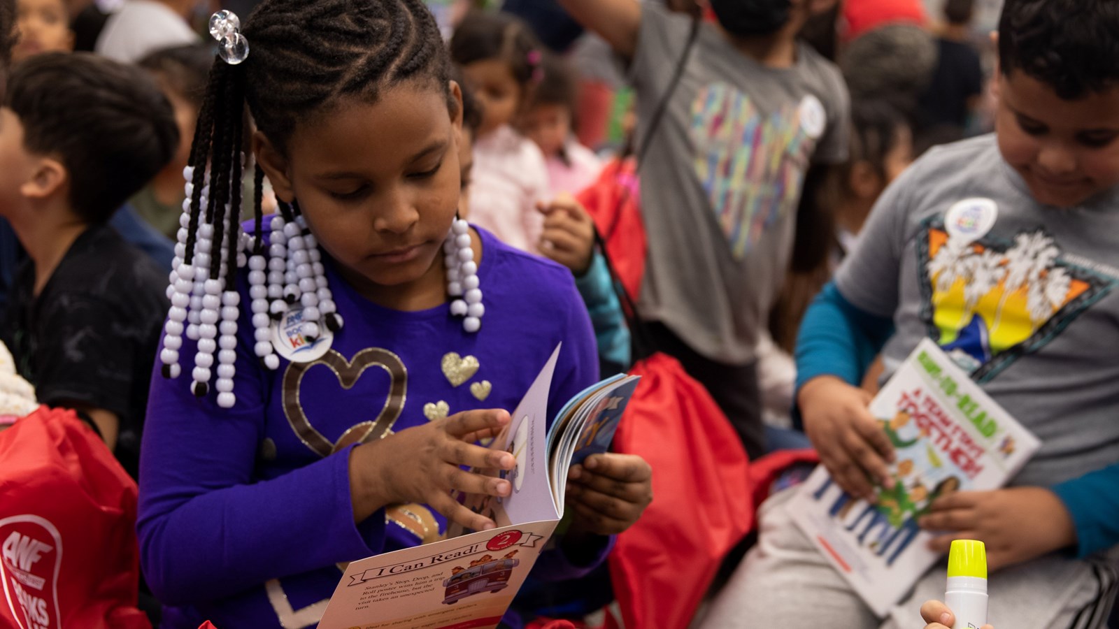 Fair Oaks Elementary School students read through the books they received during a community donation.